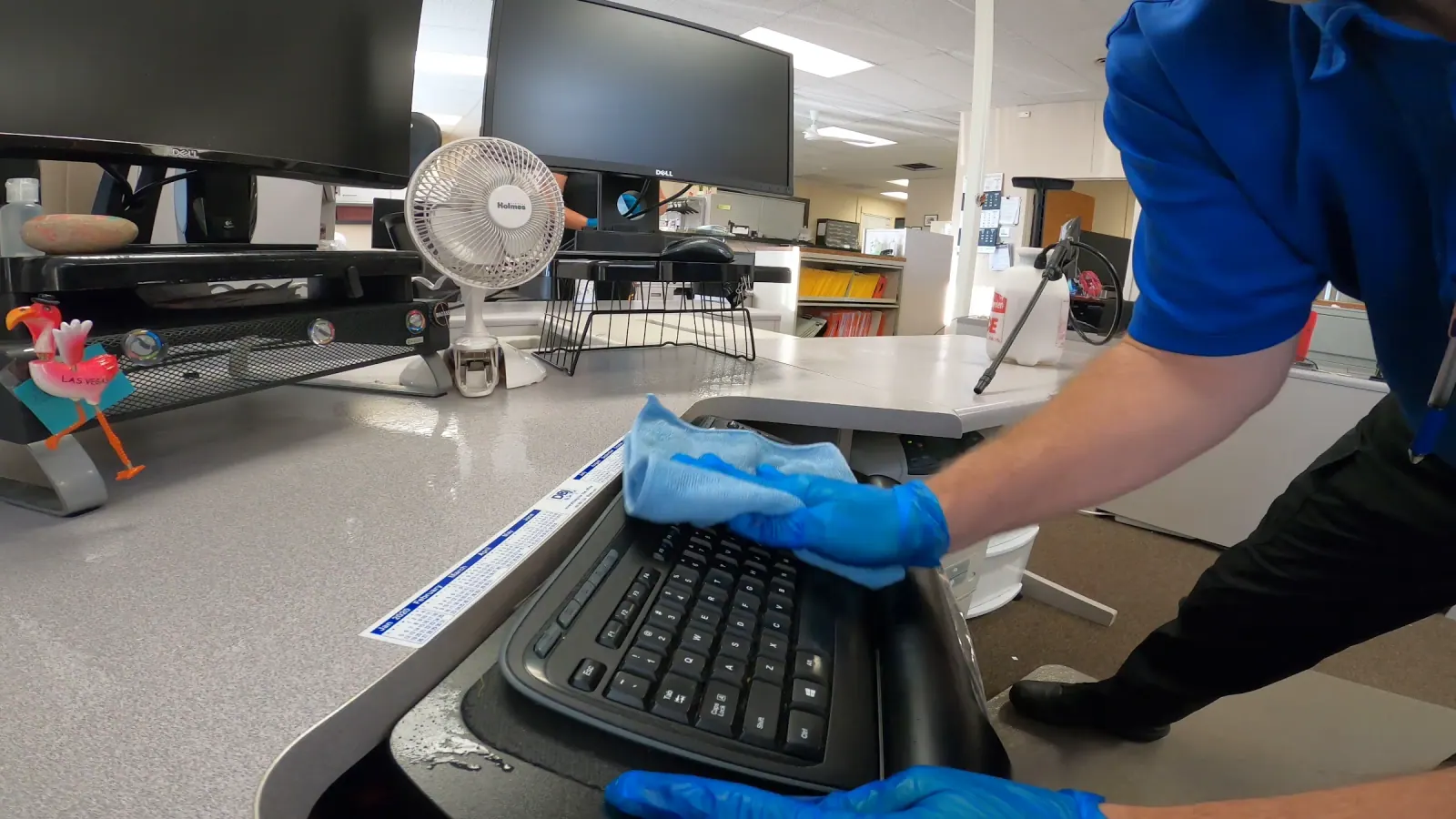 Technician detail-cleaning a Washington office workstation